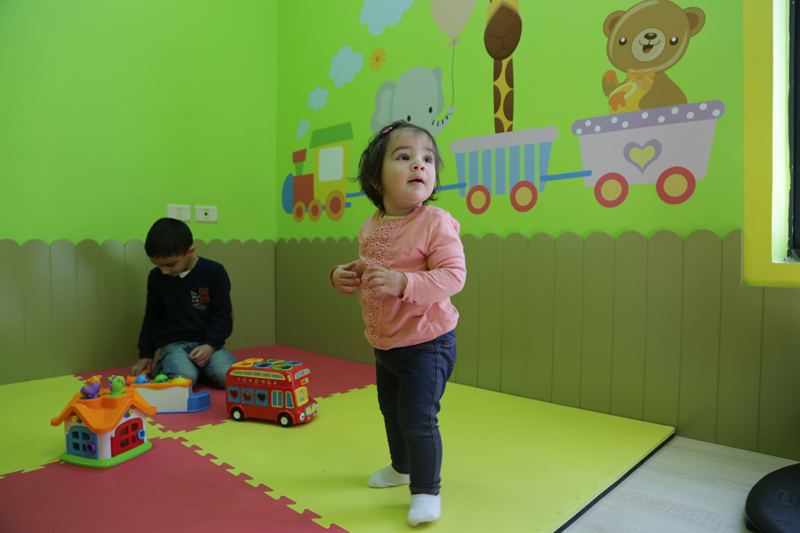 Children playing in a bright therapy room