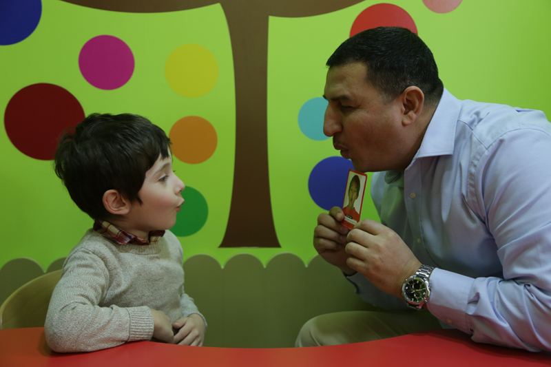 Therapist practising speech sounds with a child